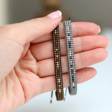 Silver and Brown Morse Code Bracelets on a hand